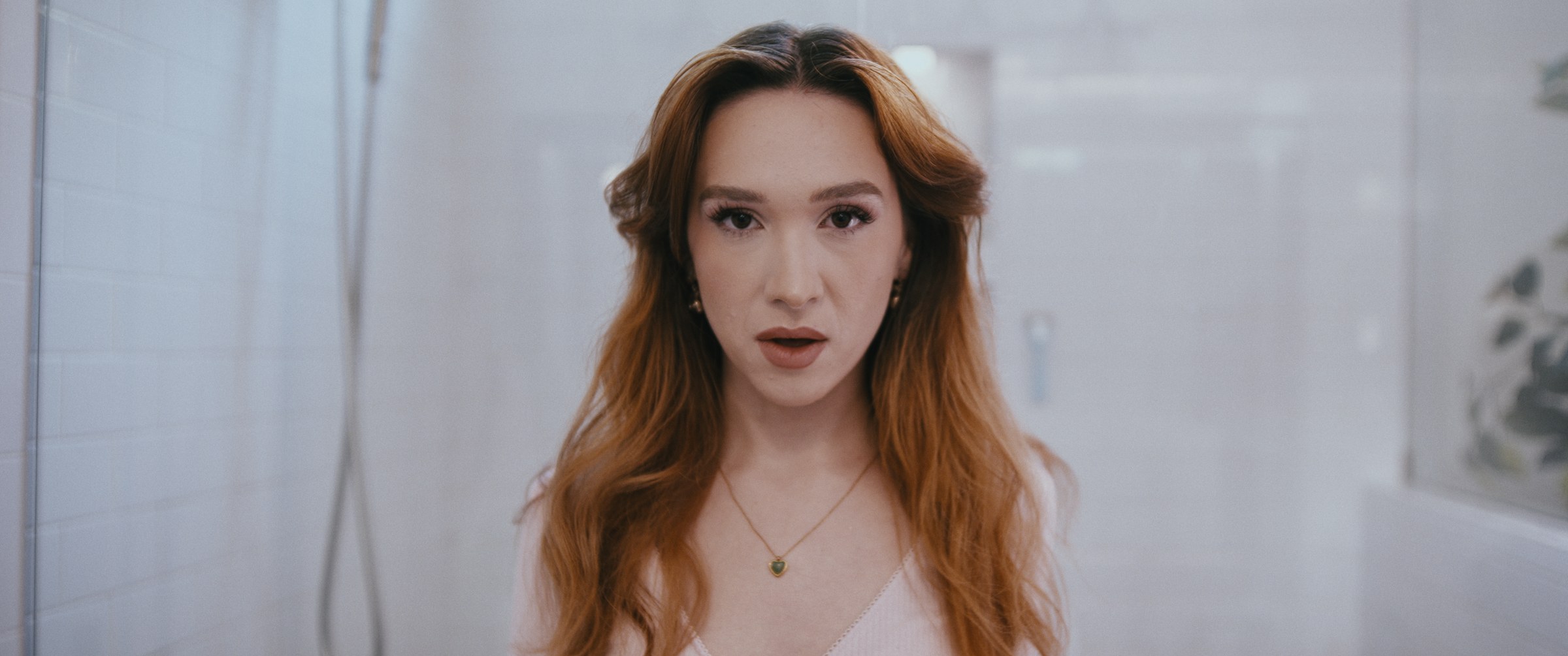 GLIMMR – Woman surprised, looking at camera in bathroom